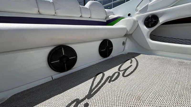 Slide: The Image of Interior of a 2005 Baja 33 Outlaw boat with white seating and speakers. - 16
