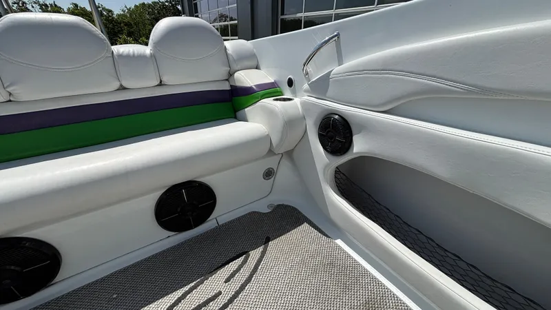 Slide: The Image of Interior of a 2005 Baja 33 Outlaw boat with white seating and speakers. - 17