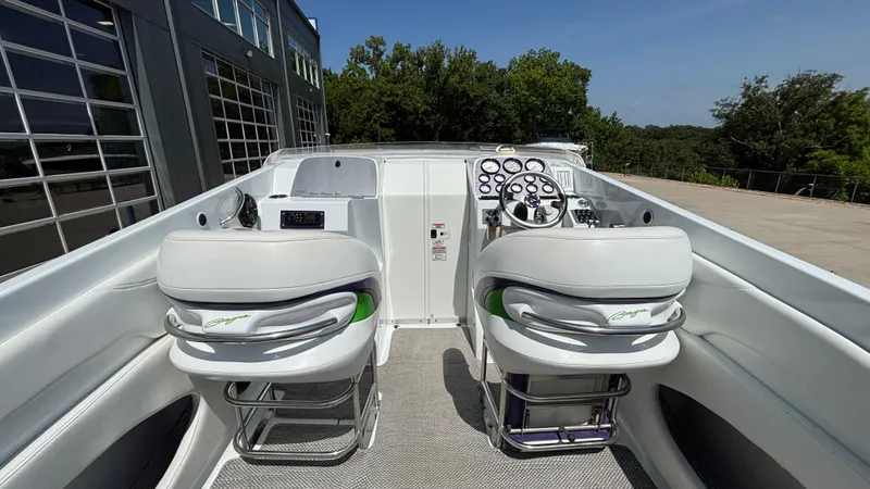 Slide: The Image of 2005 Baja 33 Outlaw boat cockpit with dual seats and control panel. - 18