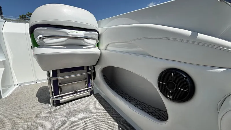 Slide: The Image of 2005 Baja 33 Outlaw boat interior with white seating and speaker detail. - 19