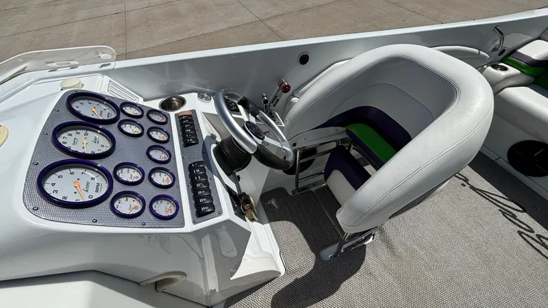 Slide: The Image of 2005 Baja 33 Outlaw boat cockpit with steering wheel and instrument panel. - 22