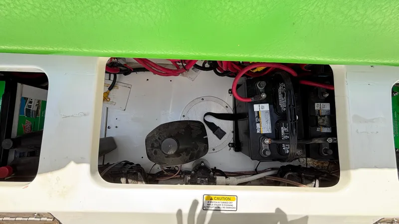 Slide: The Image of 2005 Baja 33 Outlaw boat battery compartment with wiring and components. - 25