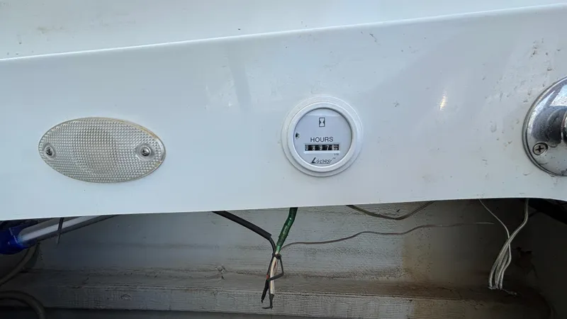 Slide: The Image of Hour meter on a 2005 Baja 33 Outlaw boat dashboard, displaying 1847 hours. - 30