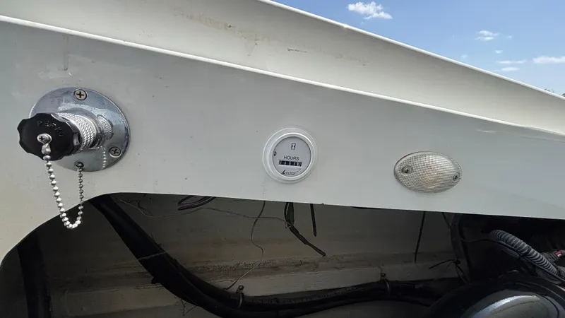 Slide: The Image of 2005 Baja 33 Outlaw boat dashboard with hour meter and fuel cap. - 31