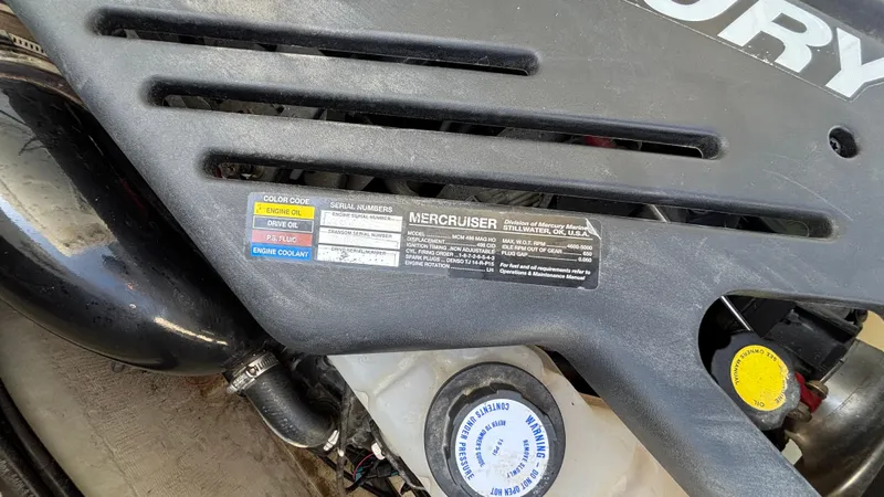 Slide: The Image of Engine compartment of a 2005 Baja 33 Outlaw boat, featuring a Mercury engine. - 33