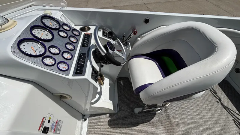 Slide: The Image of 2005 Baja 33 Outlaw boat cockpit with steering wheel and instrument panel. - 36