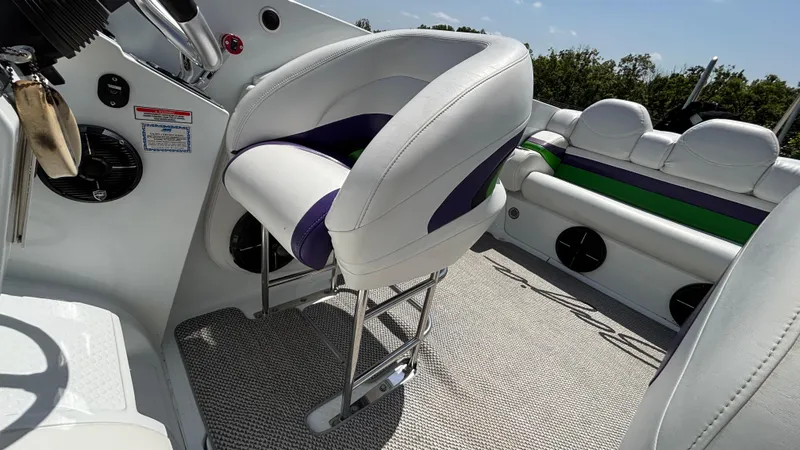 Slide: The Image of 2005 Baja 33 Outlaw boat interior with white and purple seating, steering wheel, and speakers. - 37