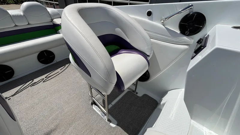 Slide: The Image of 2005 Baja 33 Outlaw boat interior with white and purple seating, modern design. - 38
