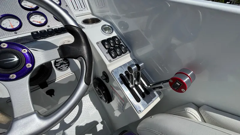 Slide: The Image of 2005 Baja 33 Outlaw boat cockpit with steering wheel and control panel. - 41