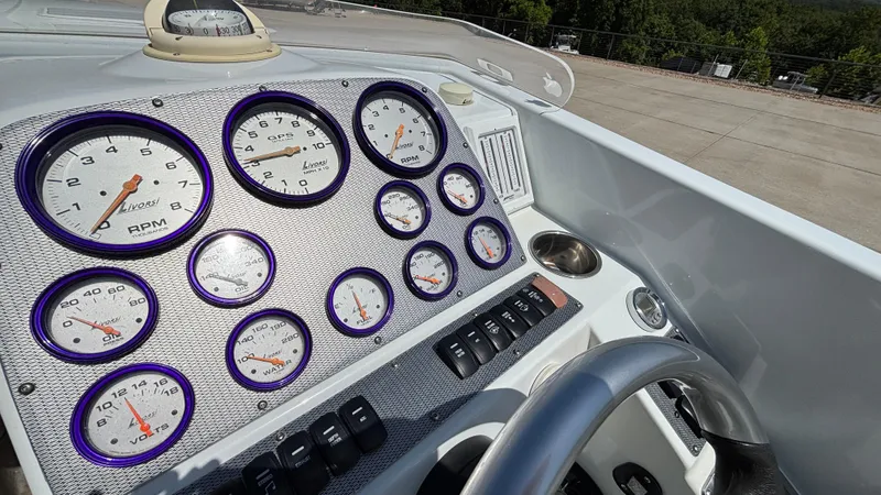 Slide: The Image of Dashboard of a 2005 Baja 33 Outlaw boat with Livorsi gauges and steering wheel. - 42