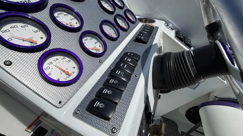 Slide: The Image of Dashboard of a 2005 Baja 33 Outlaw boat with gauges and controls. - 43