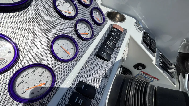 Slide: The Image of Dashboard of a 2005 Baja 33 Outlaw boat with gauges and controls. - 44