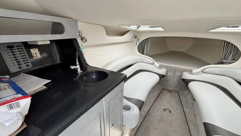 Slide: The Image of 2005 Baja 33 Outlaw cabin interior with seating, sink, and control panel. - 45