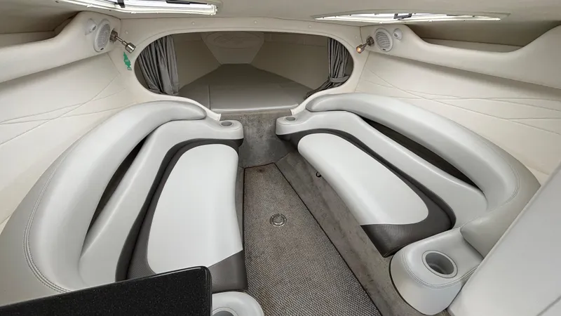 Slide: The Image of 2005 Baja 33 Outlaw cabin interior with sleek white and gray seating, modern design. - 46
