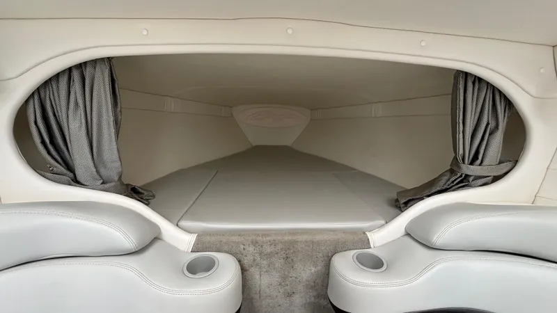 Slide: The Image of 2005 Baja 33 Outlaw cabin interior with seating and curtains. - 47