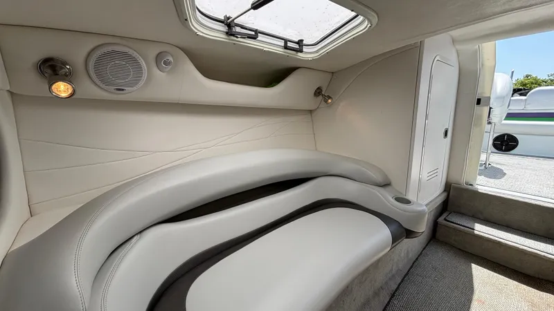 Slide: The Image of Interior of a 2005 Baja 33 Outlaw boat, featuring sleek white seating and modern lighting. - 48