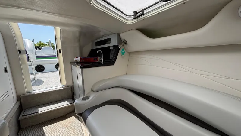 Slide: The Image of Interior of 2005 Baja 33 Outlaw boat with seating and small kitchenette. - 49