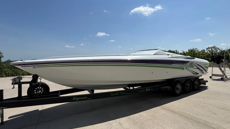Slide: The Image of 2005 Baja 33 Outlaw speedboat on trailer under clear blue sky. - 7