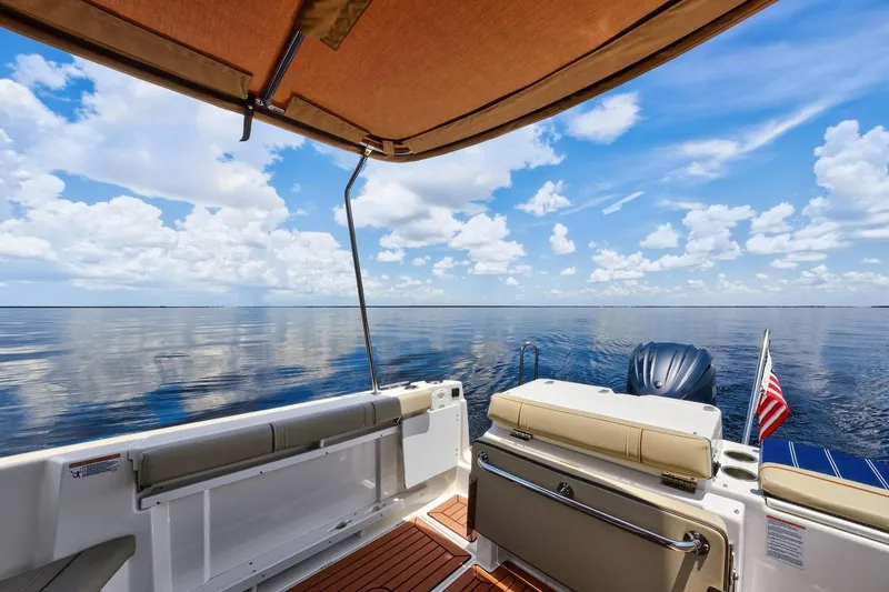 Slide: The Image of 2024 Ranger Tugs R-27 boat interior with ocean view and American flag. - 16