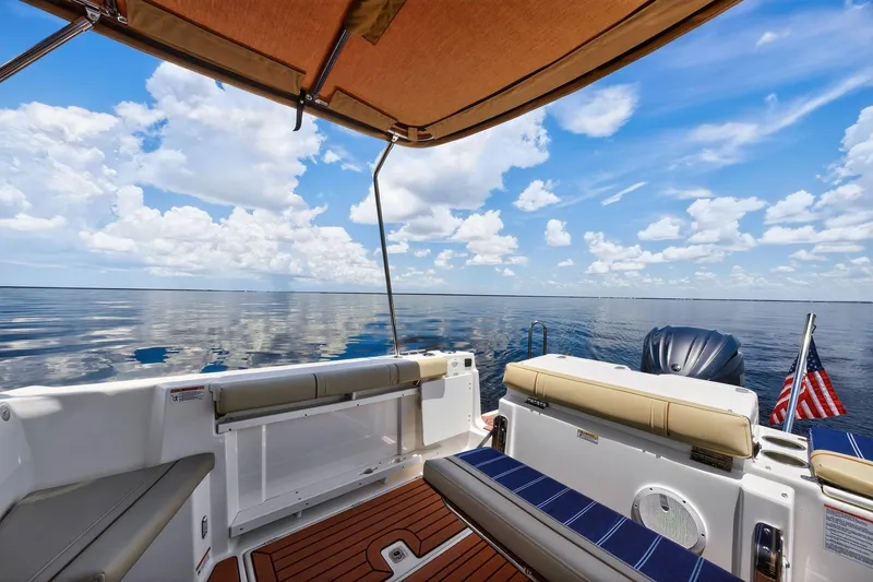 Slide: The Image of 2024 Ranger Tugs R-27 boat interior with ocean view and American flag. - 18