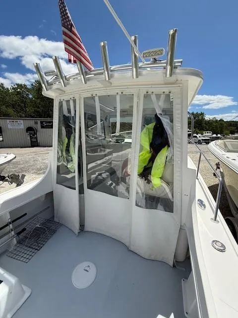 Slide: The Image of 2020 Steiger Craft 23 Miami boat with enclosed cabin and American flag. - 10