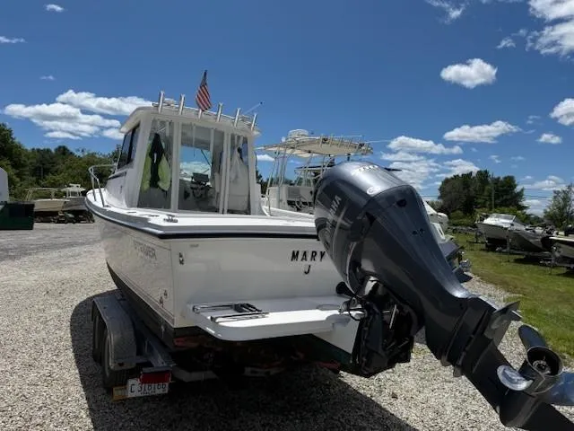 Slide: The Image of 2020 Steiger Craft 23 Miami boat on trailer with outboard motor, under a clear blue sky. - 3