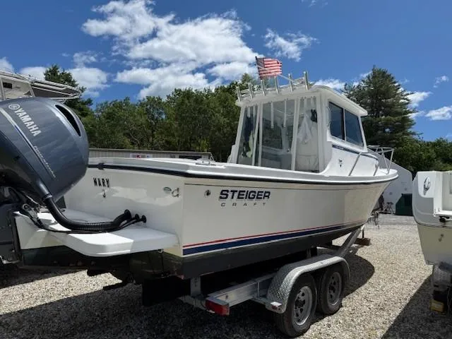 Slide: The Image of 2020 Steiger Craft 23 Miami boat on trailer, Yamaha engine, American flag, clear sky. - 4