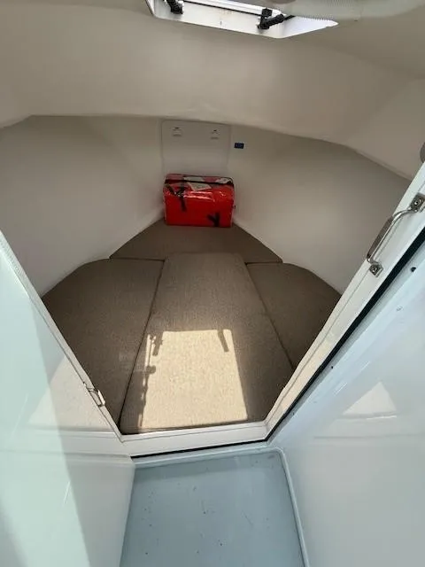 Slide: The Image of 2020 Steiger Craft 23 Miami cabin interior with red cooler and beige carpeting. - 5