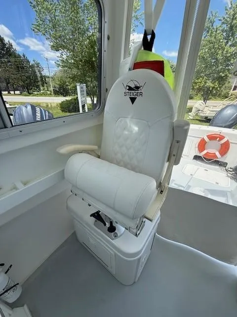 Slide: The Image of 2020 Steiger Craft 23 Miami boat interior with white captain's chair and life preserver. - 8