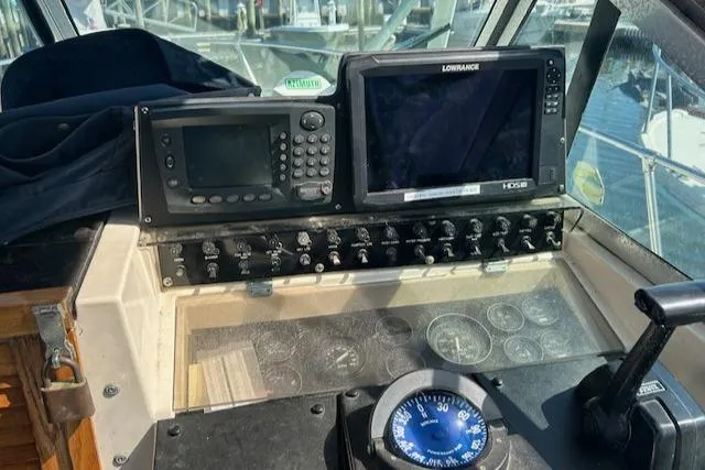 Slide: The Image of Control panel of a 1983 Grady-White TrophyPro boat with navigation equipment. - 4