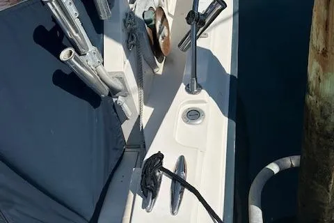 Slide: The Image of 1983 Grady-White TrophyPro boat deck with fishing rod holders and mooring line. - 6