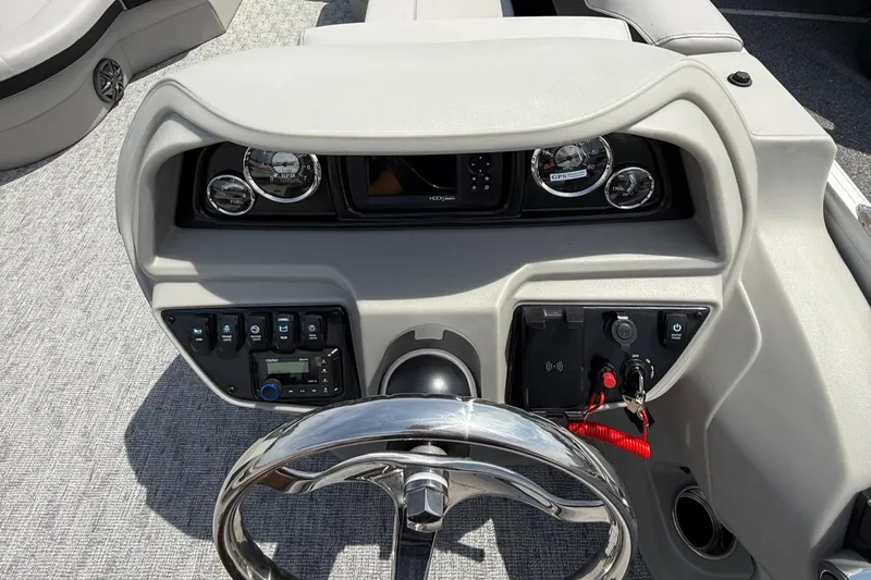 Slide: The Image of 2025 Berkshire 20CL LE 2.75 boat dashboard with steering wheel and control panel. - 13