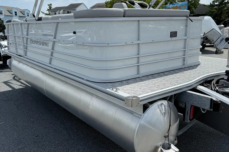 Slide: The Image of 2025 Berkshire 20CL LE 2.75 pontoon boat, saltwater edition, parked on a trailer. - 2