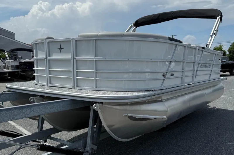 Slide: The Image of 2025 Berkshire 20CL LE 2.75 pontoon boat on trailer, under cloudy sky. - 7