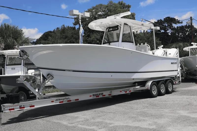 The Image of 2025 Regulator 31 boat on trailer, parked outdoors under blue sky. - 0