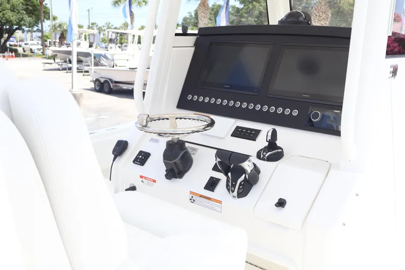 Slide: The Image of 2025 Regulator 31 boat dashboard with dual screens and modern controls. - 11