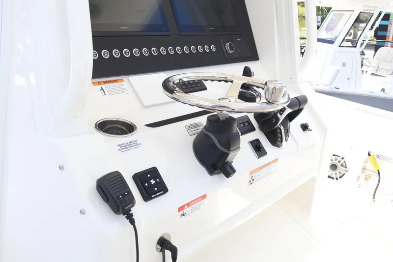 Slide: The Image of 2025 Regulator 31 boat dashboard with steering wheel and control panel. - 13