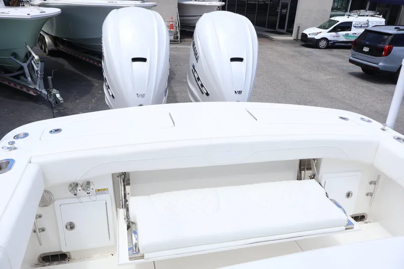 Slide: The Image of 2025 Regulator 31 boat with dual V8 engines, white interior, and outdoor showroom setting. - 18
