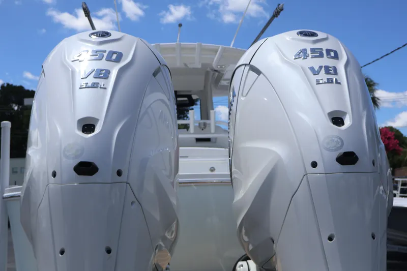 Slide: The Image of 2025 Regulator 31 boat with dual 450 V8 engines, under a clear blue sky. - 2