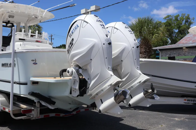 Slide: The Image of 2025 Regulator 31 boat with twin Yamaha 425 engines, parked outdoors. - 21