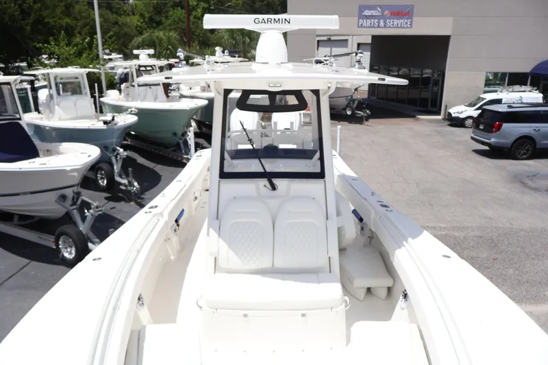 Slide: The Image of 2025 Regulator 31 boat with Garmin equipment at a dealership, surrounded by other boats. - 7