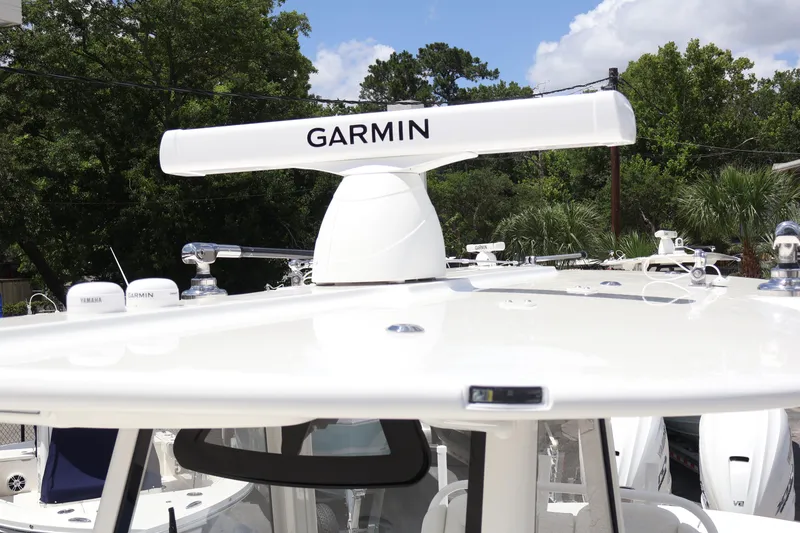 Slide: The Image of 2025 Regulator 31 boat with Garmin radar, surrounded by trees and clear sky. - 8