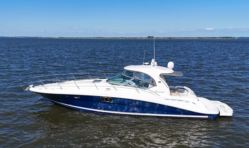 The Image of 2008 Sea Ray 44 Sundancer yacht cruising on open water under clear blue sky. - 0