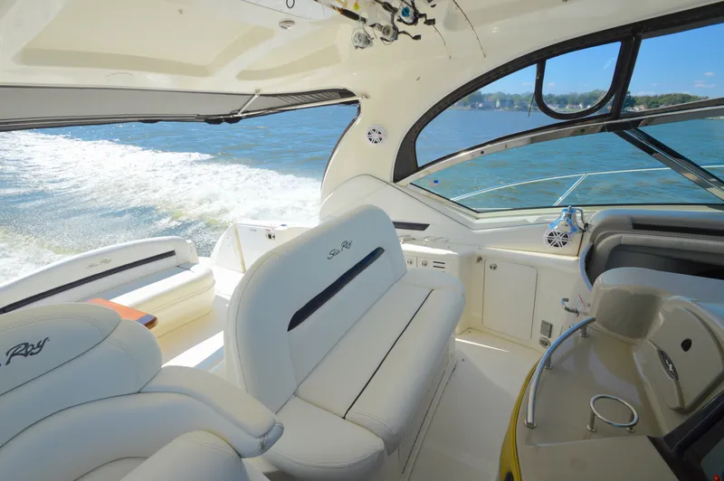 Slide: The Image of Interior view of 2008 Sea Ray 44 Sundancer yacht with luxurious seating and open water backdrop. - 11