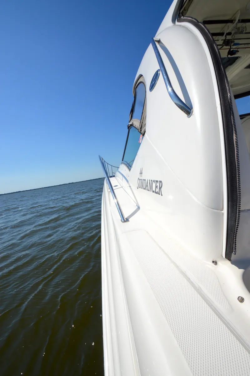 Slide: The Image of 2008 Sea Ray 44 Sundancer yacht on open water under clear blue sky. - 19