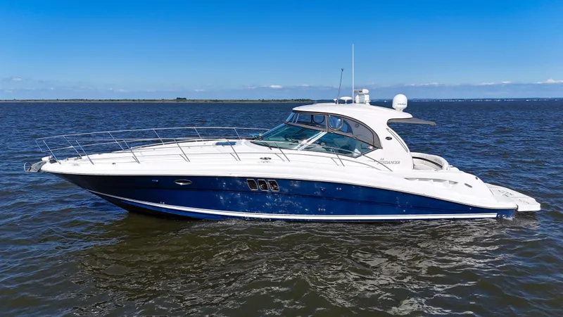 Slide: The Image of 2008 Sea Ray 44 Sundancer yacht cruising on open water under clear blue sky. - 4