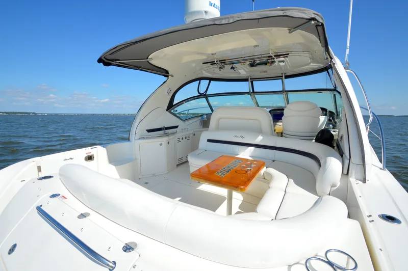 Slide: The Image of 2008 Sea Ray 44 Sundancer yacht with spacious seating, cruising on open water. - 6