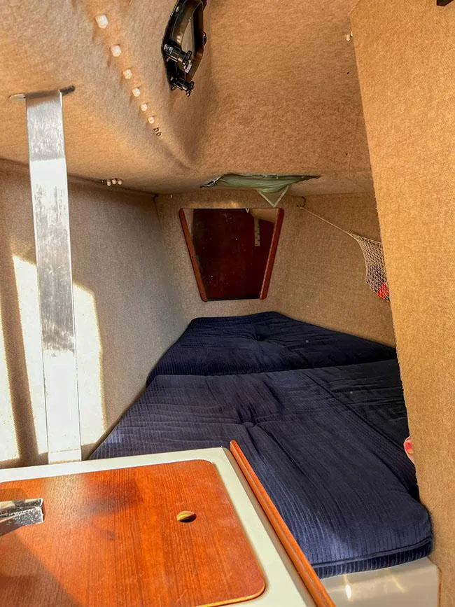 Slide: The Image of Interior cabin of a 1982 S2 7.9 sailboat with blue cushions and wooden accents. - 17