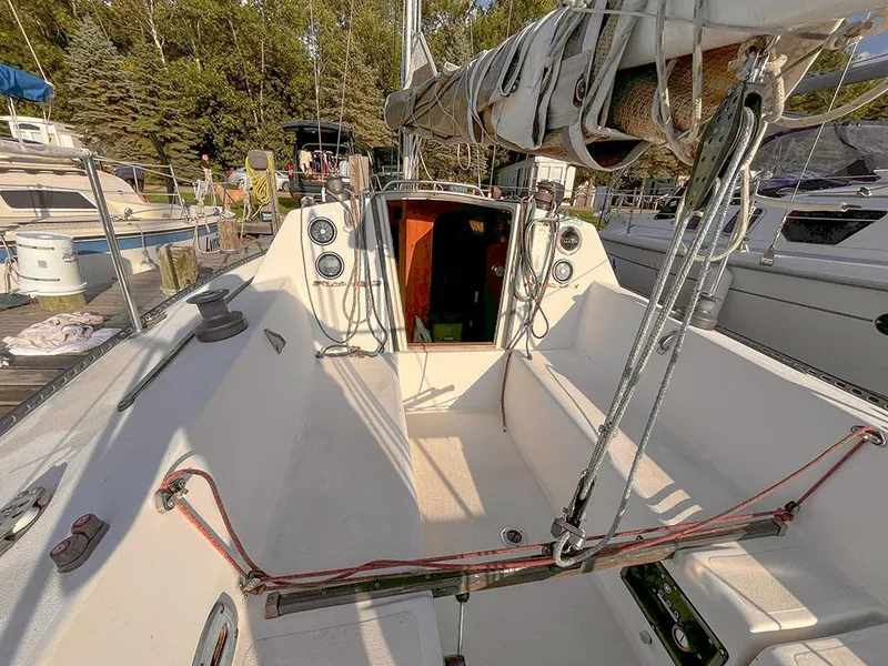 Slide: The Image of 1982 S2 7.9 sailboat cockpit with rigging, docked among other boats. - 9
