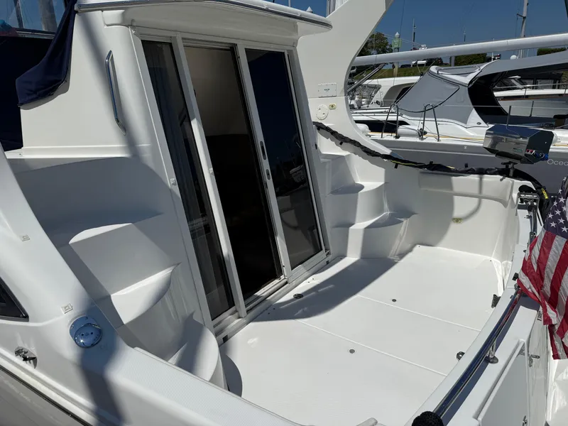 Slide: The Image of 2006 Carver 36 Mariner yacht deck with sliding doors and American flag. - 1